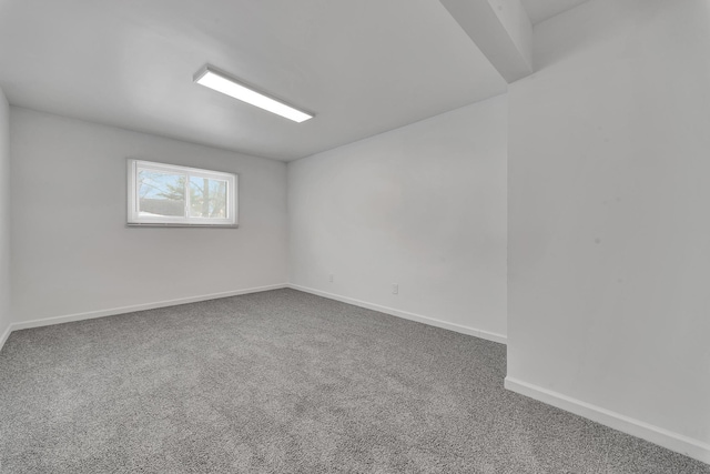 spare room with carpet flooring and baseboards