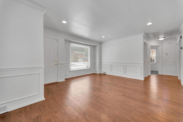 spare room featuring attic access, recessed lighting, ornamental molding, and wood finished floors