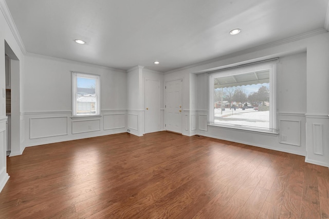 unfurnished room with recessed lighting, wainscoting, crown molding, and wood finished floors