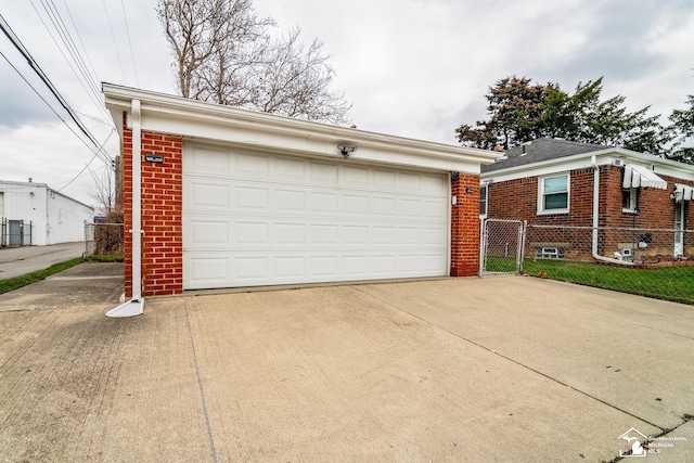 detached garage featuring a gate and fence