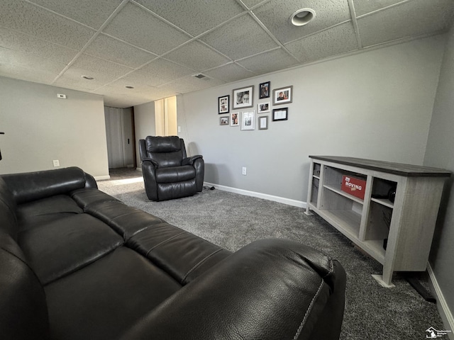 carpeted living area with a drop ceiling, visible vents, and baseboards