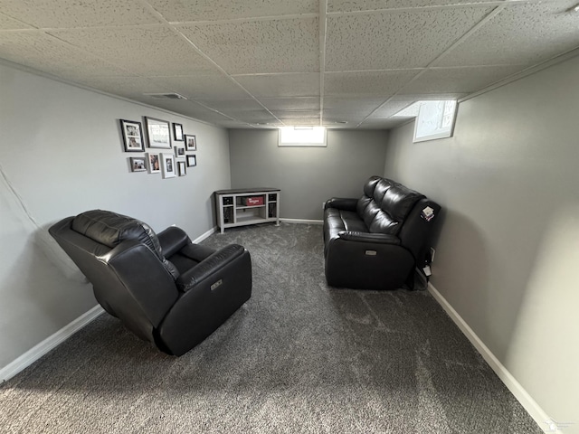 living area with carpet floors, a drop ceiling, visible vents, and baseboards