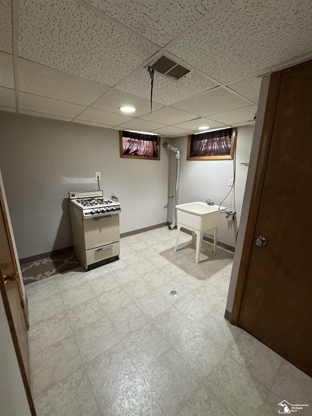 bathroom with a paneled ceiling, visible vents, baseboards, and tile patterned floors