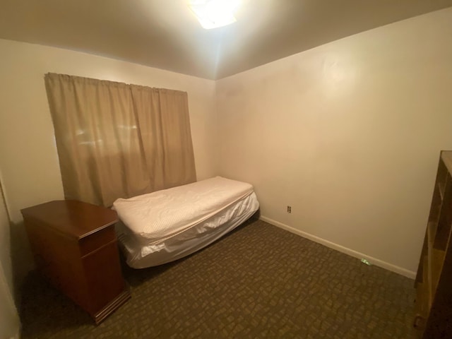 bedroom featuring carpet flooring and baseboards