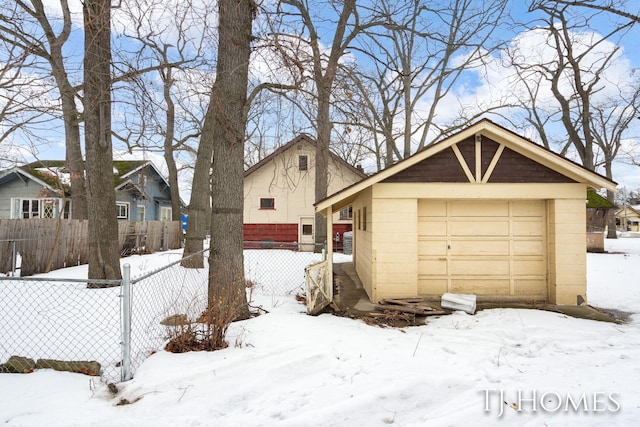 view of front facade with a garage, concrete block siding, and fence