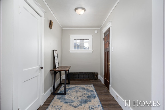 corridor with ornamental molding, dark wood finished floors, and baseboards