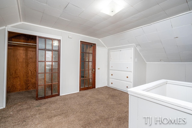 bonus room featuring carpet and vaulted ceiling