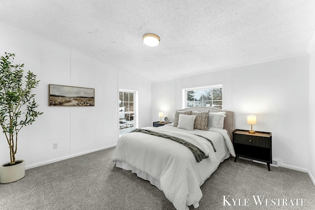 carpeted bedroom with baseboards and a textured ceiling