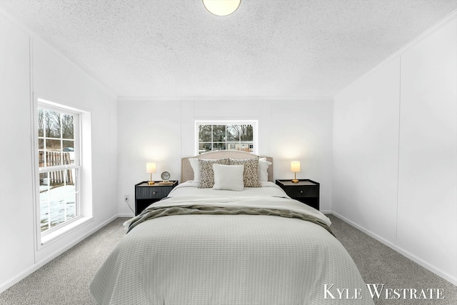 carpeted bedroom featuring baseboards and a textured ceiling