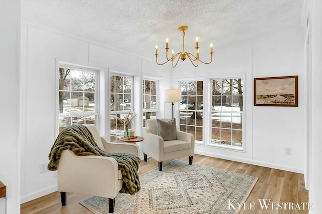 sunroom featuring a chandelier