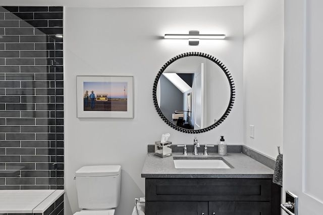 bathroom featuring vanity and toilet