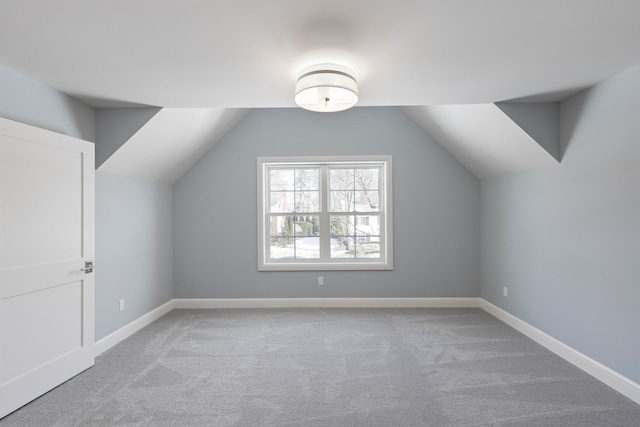 bonus room featuring vaulted ceiling, carpet floors, and baseboards