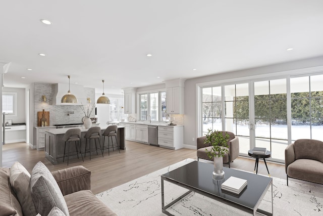 living area featuring recessed lighting and light wood-style floors