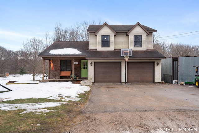 view of front facade with aphalt driveway, covered porch, roof with shingles, and a garage