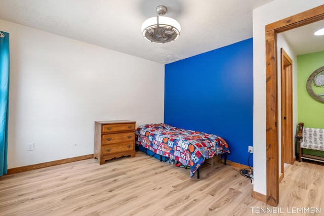 bedroom with wood finished floors and baseboards