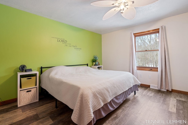 bedroom with wood finished floors, a ceiling fan, and baseboards