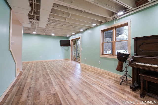 basement with baseboards and wood finished floors