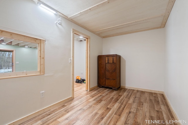 unfurnished room with baseboards and wood finished floors