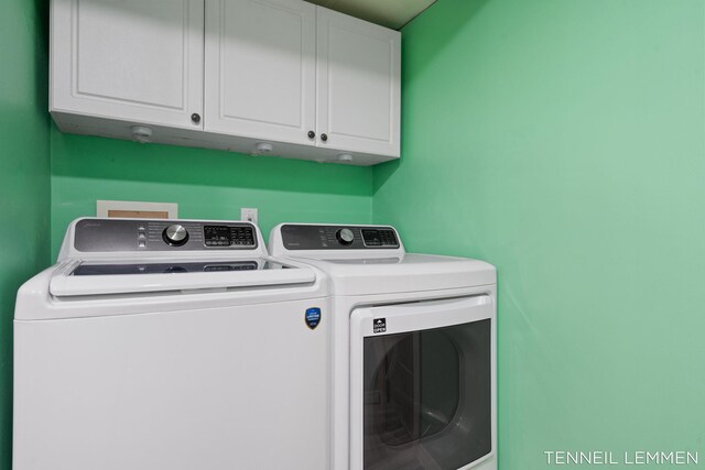 laundry room with cabinet space and washer and clothes dryer