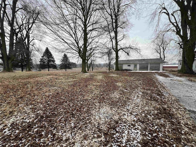 view of yard featuring gravel driveway and an attached garage