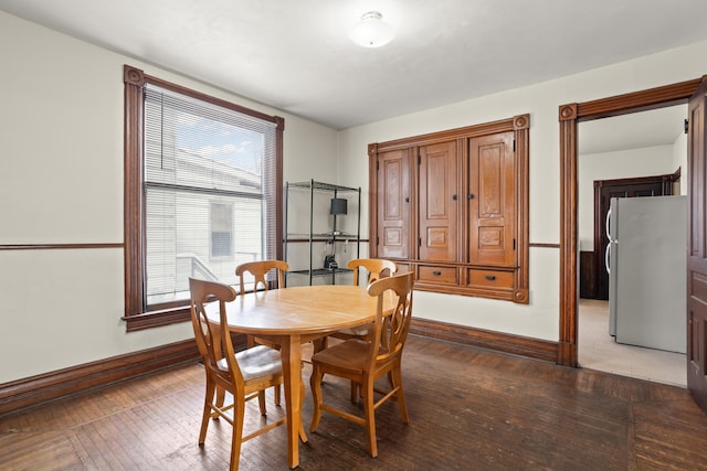 dining room featuring hardwood / wood-style floors and baseboards