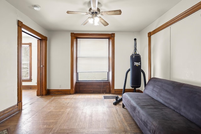 unfurnished bedroom featuring a closet, wood-type flooring, visible vents, a ceiling fan, and baseboards