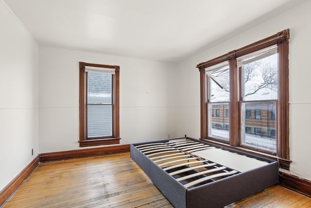 bedroom featuring baseboards and hardwood / wood-style floors