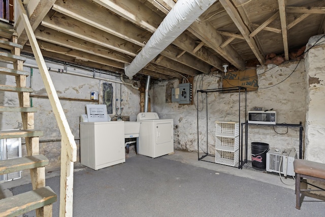 unfinished basement featuring washer and dryer and electric panel