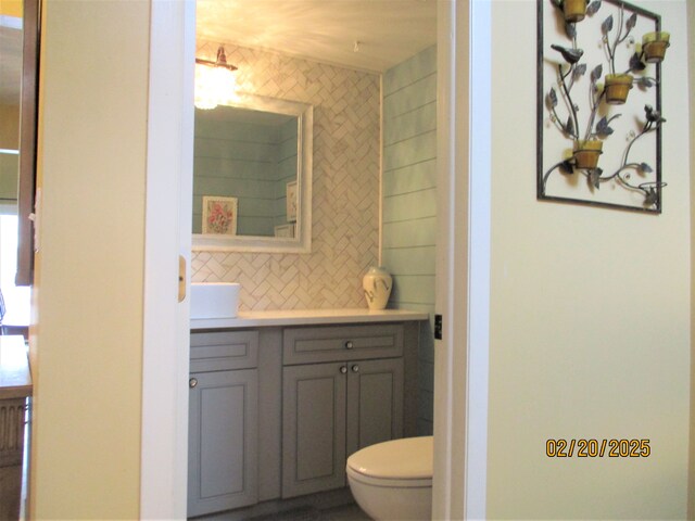 bathroom featuring decorative backsplash, vanity, and toilet