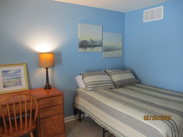 carpeted bedroom featuring visible vents