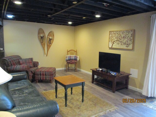 living room featuring wood finished floors and baseboards