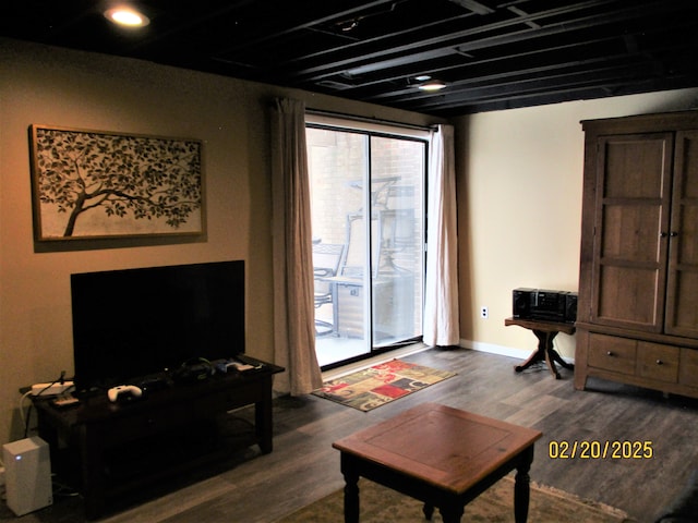 living room featuring dark wood-style flooring and baseboards