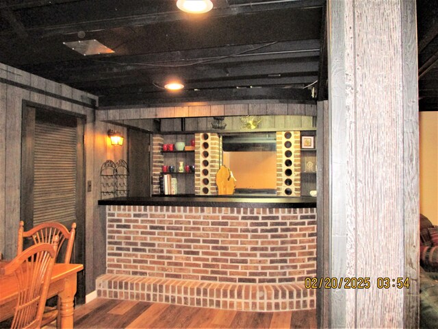 wine cellar featuring a dry bar and wood finished floors