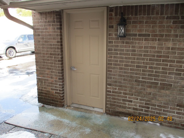 property entrance with brick siding