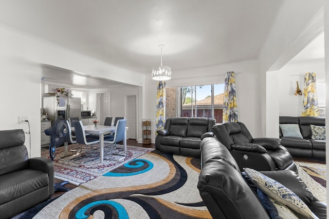 living room featuring an inviting chandelier and wood finished floors