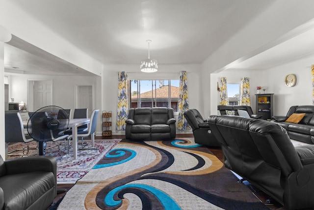 living area featuring wood finished floors and an inviting chandelier