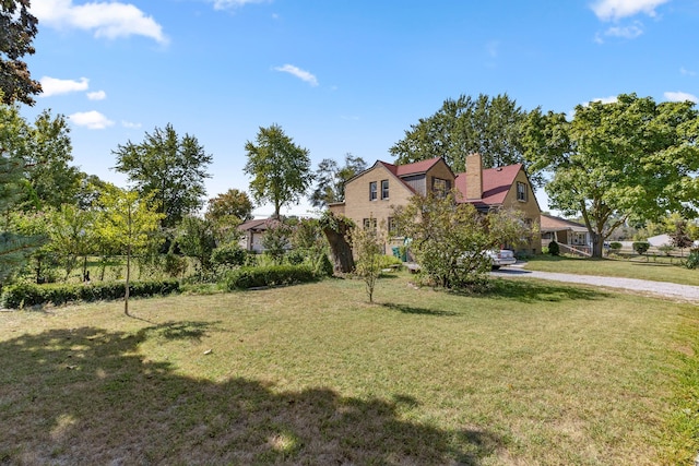 view of front of home with a front yard, fence, and a chimney