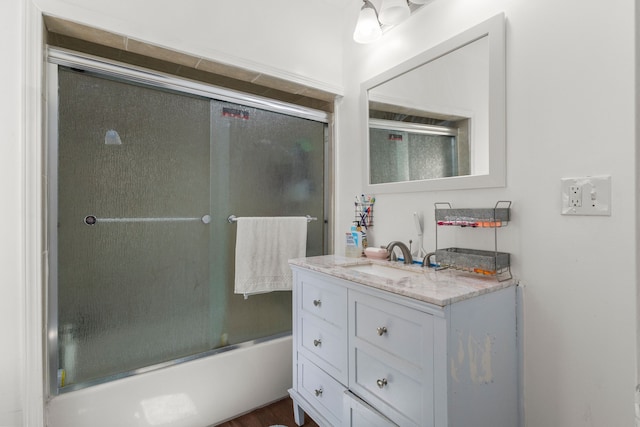 bathroom with enclosed tub / shower combo and vanity