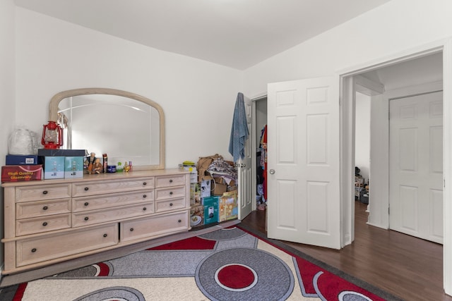 bedroom featuring lofted ceiling and wood finished floors