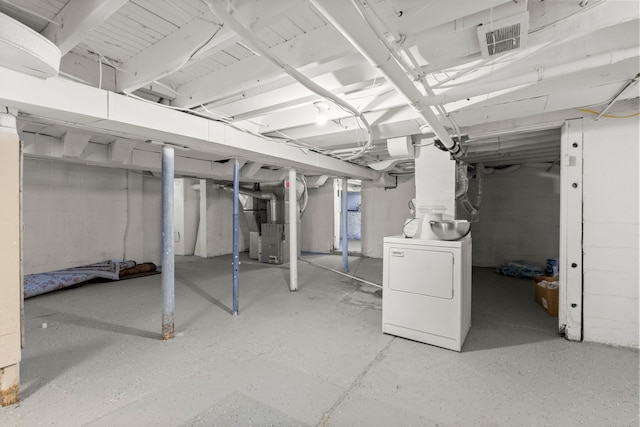 unfinished below grade area with heating unit, washer / dryer, and visible vents