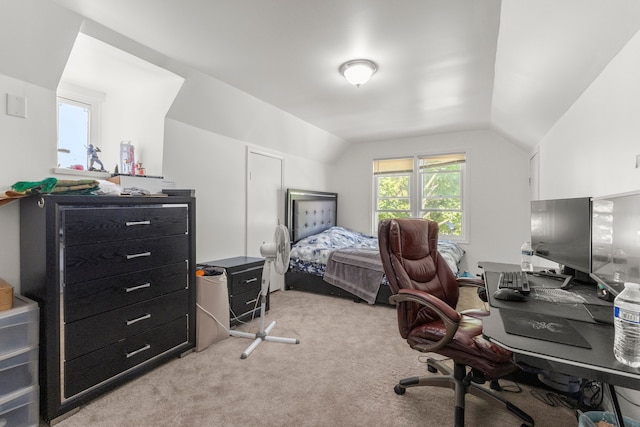 bedroom with vaulted ceiling and light colored carpet