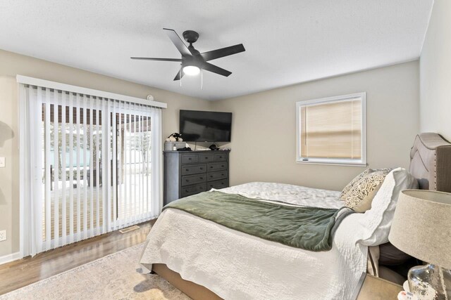 5235 Lahring Rd, Linden, MI 48451 - bedroom featuring baseboards, access to outside, ceiling fan, and wood finished floors