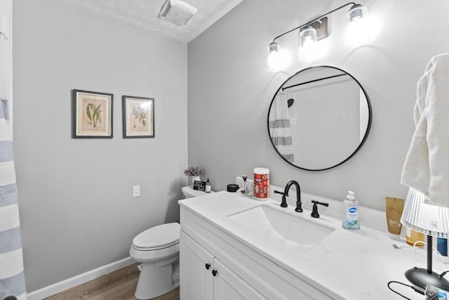 5235 Lahring Rd, Linden, MI 48451 - bathroom with vanity, visible vents, wood finished floors, toilet, and baseboards