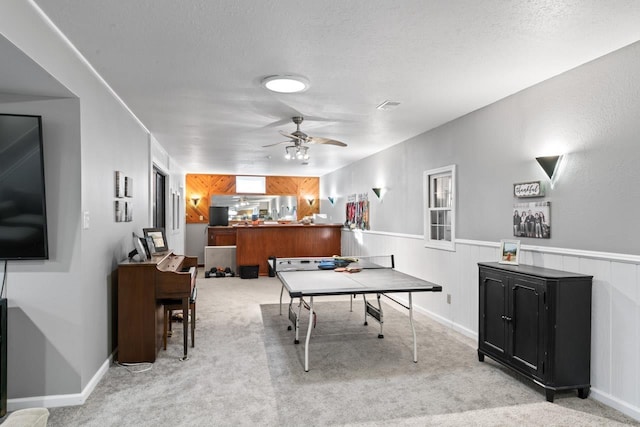 5235 Lahring Rd, Linden, MI 48451 - rec room with a wainscoted wall, ceiling fan, carpet, and a textured ceiling