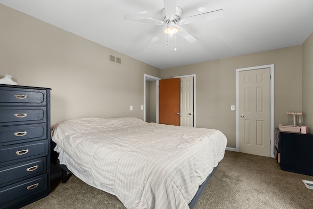 carpeted bedroom with ceiling fan and visible vents