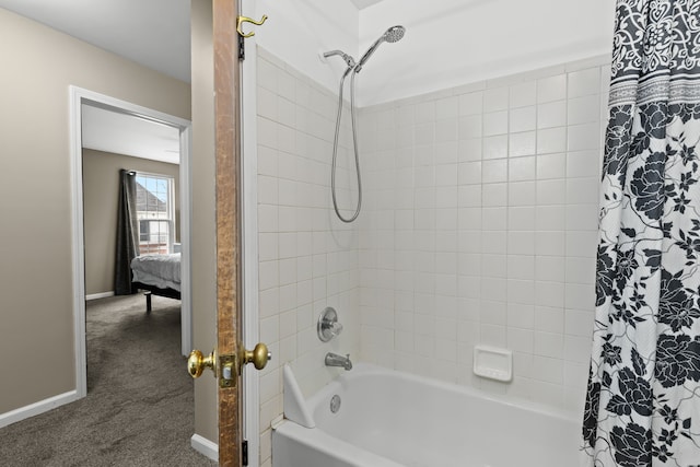 full bathroom with shower / tub combo and baseboards