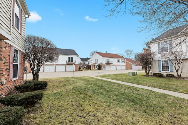 view of yard with a residential view and community garages