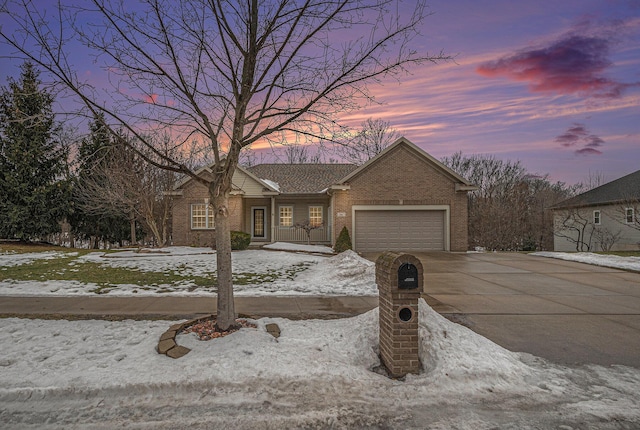 ranch-style house featuring a garage, concrete driveway, and brick siding