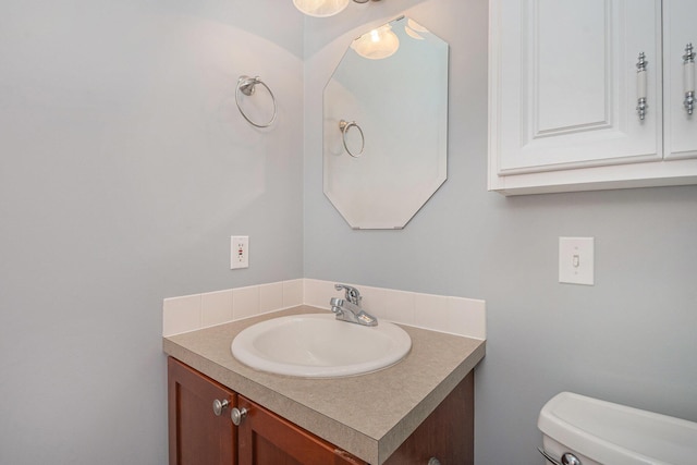 bathroom featuring toilet and vanity