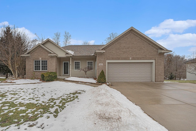 ranch-style home featuring an attached garage, concrete driveway, and brick siding